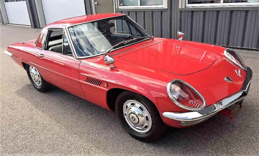 The Mazda Cosmo Sport 110S first series in its characteristic white, showing the gills on the front wings and the fastback roofline — ca. 1967