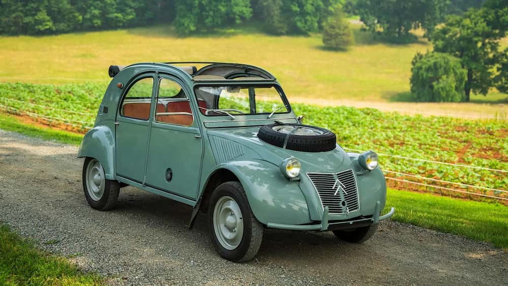 The Citroën 2CV Sahara 4×4 seen from the rear — the cooling grilles for the rear engine in the wings, the split tail lights flanking the fan, and the front bonnet with the cut-out for the spare wheel